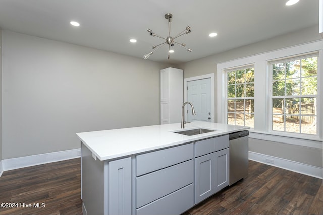 kitchen with dark wood-type flooring, a center island with sink, sink, stainless steel dishwasher, and gray cabinets