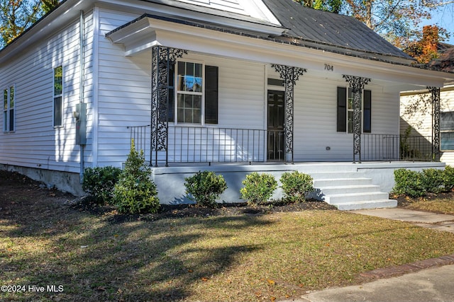 view of front of home with a front lawn and a porch