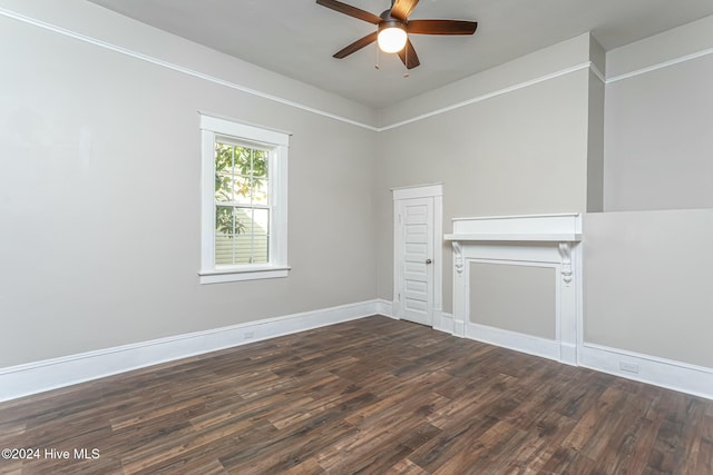 empty room featuring dark hardwood / wood-style flooring and ceiling fan