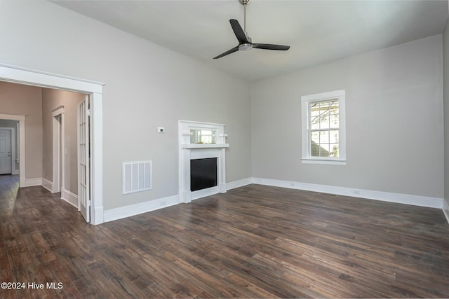 unfurnished living room featuring dark hardwood / wood-style floors and ceiling fan