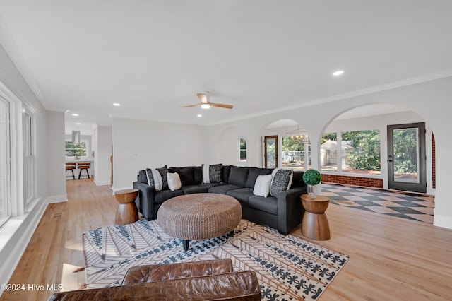 living room featuring ceiling fan, light hardwood / wood-style flooring, and ornamental molding