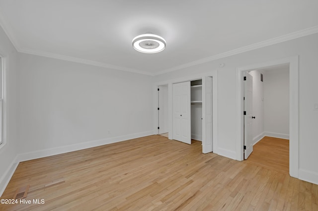 unfurnished bedroom with light hardwood / wood-style floors, a closet, and ornamental molding