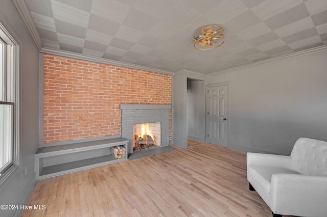 unfurnished room with light hardwood / wood-style floors, crown molding, and a brick fireplace