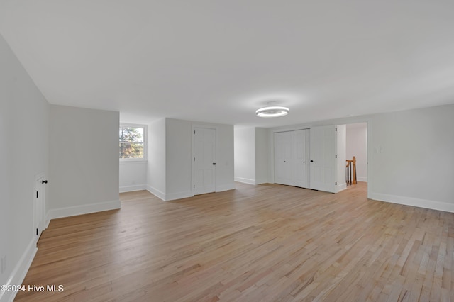 empty room with light hardwood / wood-style flooring