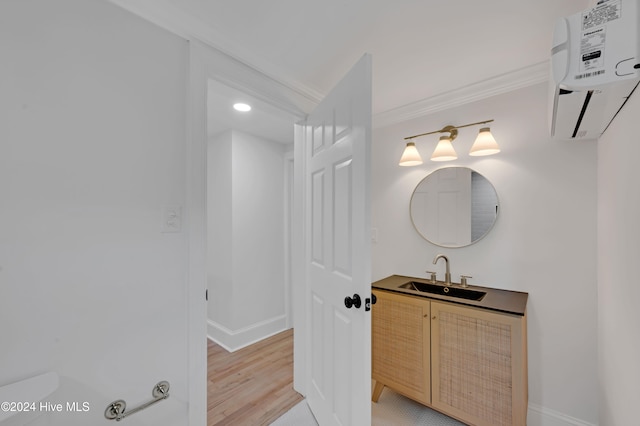 bathroom featuring vanity, toilet, wood-type flooring, and crown molding