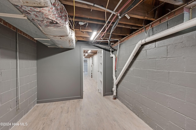 basement with hardwood / wood-style flooring