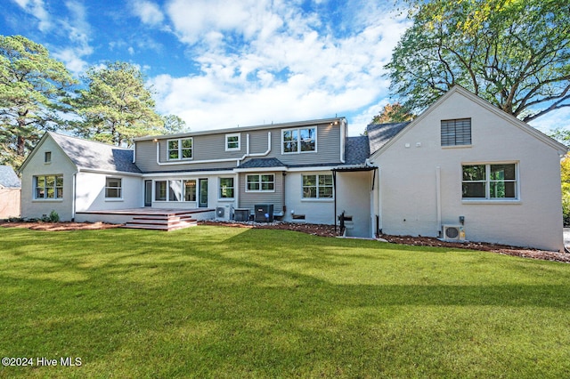 rear view of house featuring a lawn