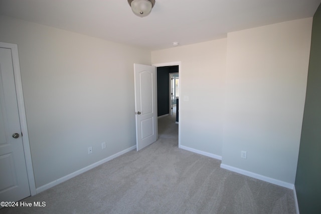 spare room with light colored carpet