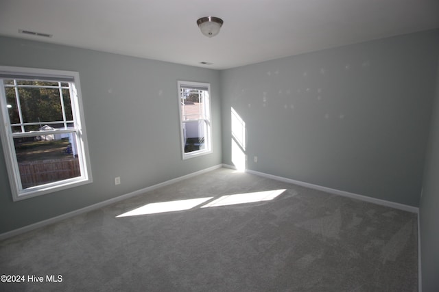 unfurnished room featuring carpet flooring