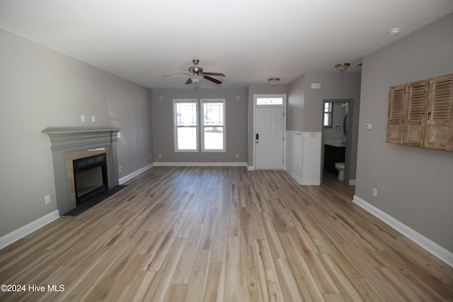 unfurnished living room with ceiling fan and light wood-type flooring