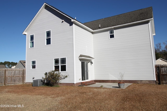 back of property featuring central AC