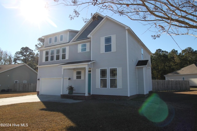 view of front of property with a garage and a front lawn