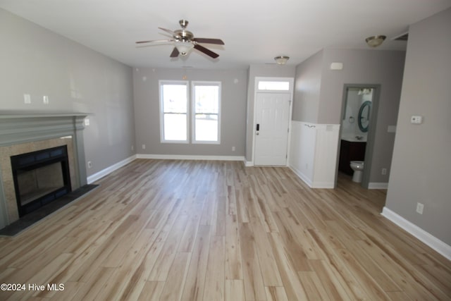 unfurnished living room featuring ceiling fan and light hardwood / wood-style flooring