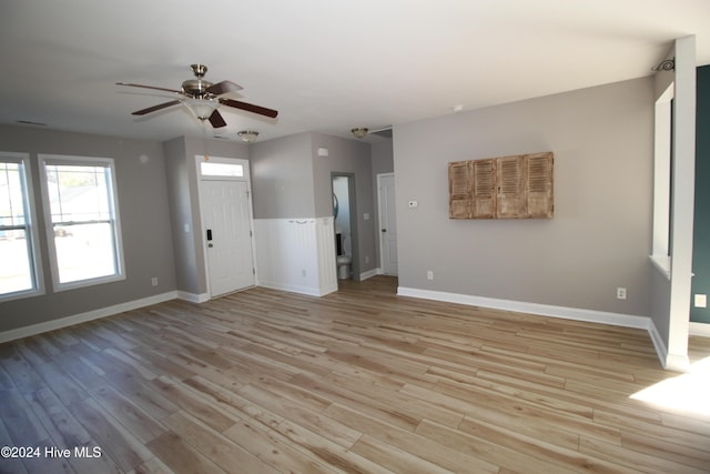 unfurnished living room with ceiling fan and light wood-type flooring