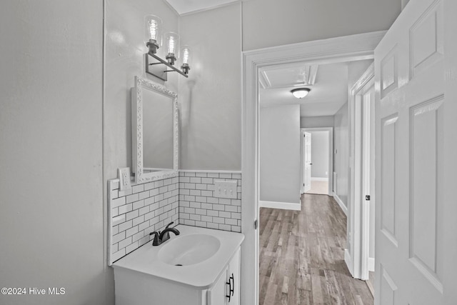 bathroom featuring vanity, wood-type flooring, and backsplash