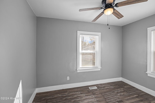 spare room featuring ceiling fan and dark wood-type flooring