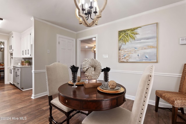 dining room featuring an inviting chandelier, dark hardwood / wood-style flooring, and ornamental molding