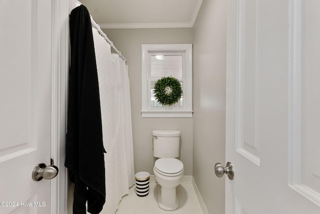 bathroom with ornamental molding and toilet