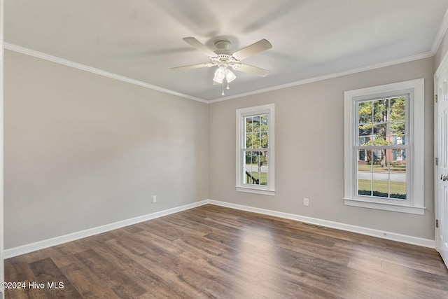 empty room with ornamental molding, dark wood-style flooring, ceiling fan, and baseboards