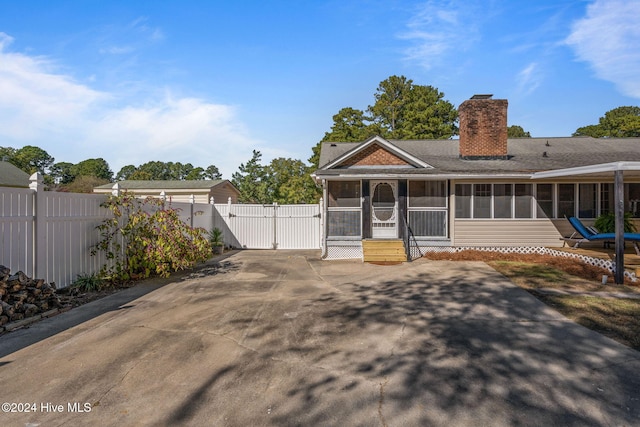 view of front of home featuring a sunroom