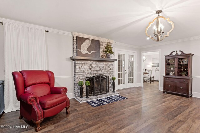 living room featuring ornamental molding, a brick fireplace, and french doors