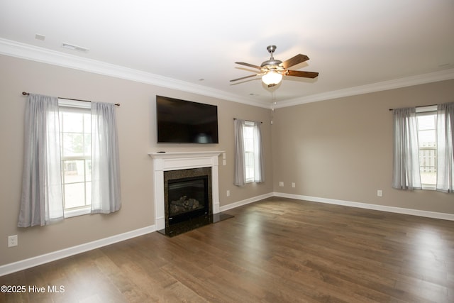 unfurnished living room featuring ceiling fan, ornamental molding, and a premium fireplace