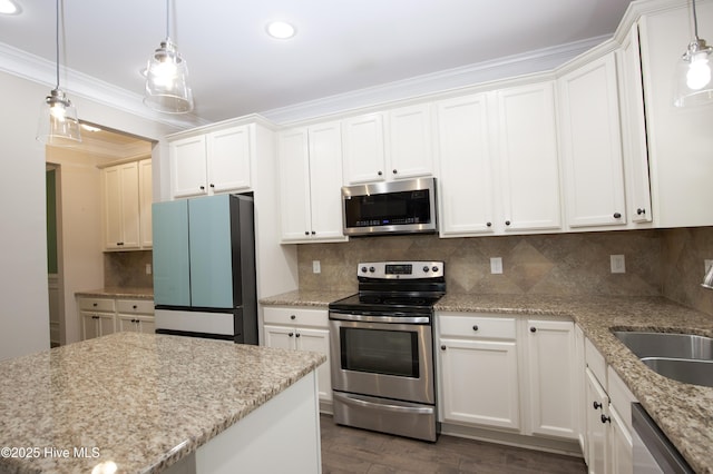 kitchen featuring white cabinets, pendant lighting, and stainless steel appliances