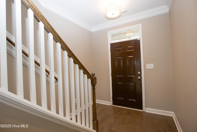 foyer featuring dark hardwood / wood-style flooring and ornamental molding