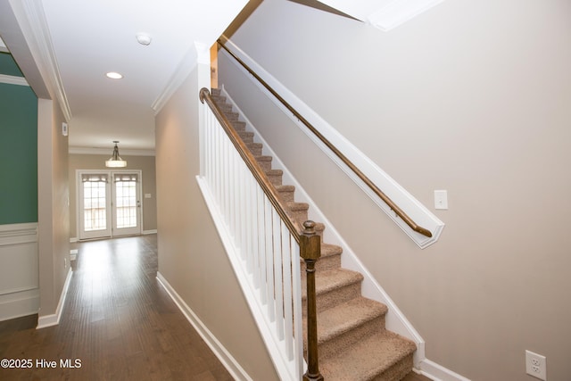 stairs with crown molding, french doors, and hardwood / wood-style flooring