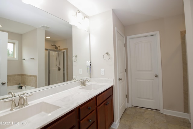 bathroom with vanity and independent shower and bath