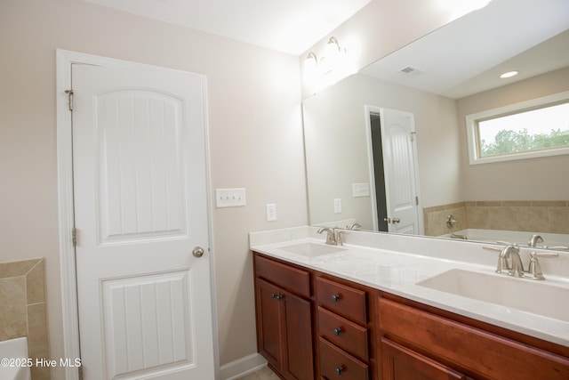 bathroom featuring vanity and a bathtub