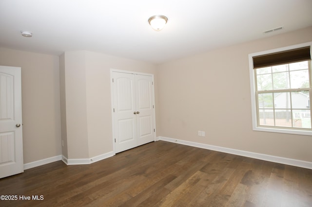 spare room with dark hardwood / wood-style floors