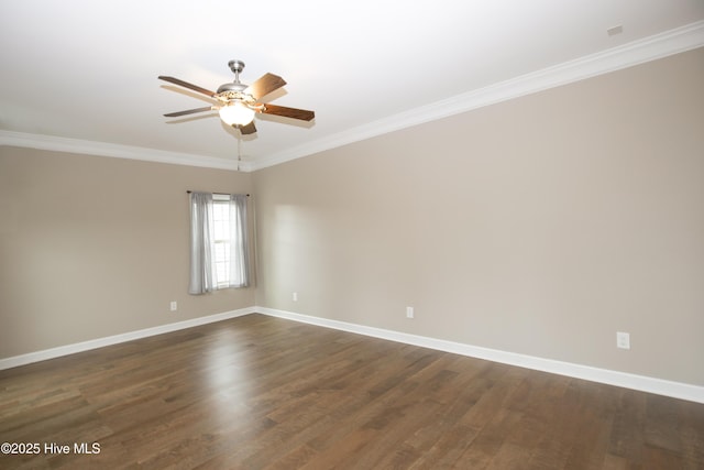 spare room featuring dark wood-type flooring, ceiling fan, and crown molding