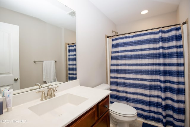 bathroom with a shower with curtain, vanity, and toilet