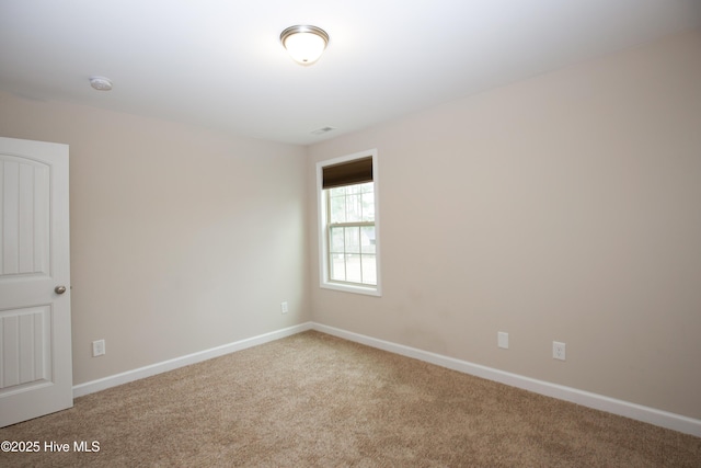 spare room with light colored carpet