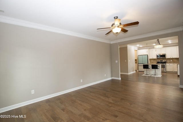 unfurnished living room with ceiling fan, crown molding, and dark wood-type flooring