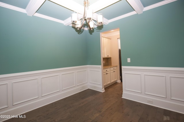 spare room featuring a notable chandelier, beam ceiling, dark hardwood / wood-style flooring, and crown molding