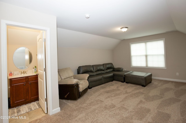 carpeted living room featuring vaulted ceiling and sink