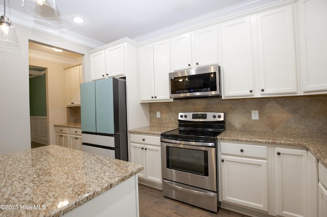 kitchen featuring tasteful backsplash, white cabinets, and stainless steel appliances