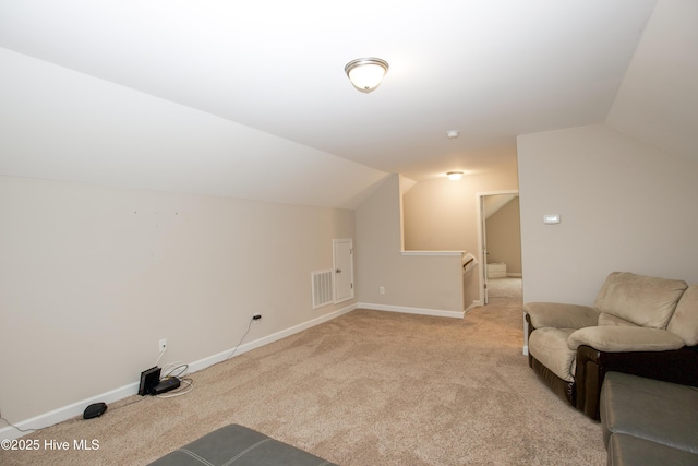 additional living space with light colored carpet and lofted ceiling