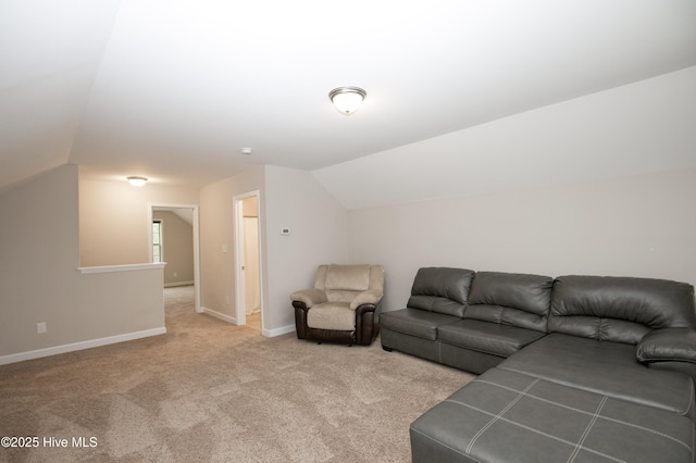 carpeted living room with vaulted ceiling