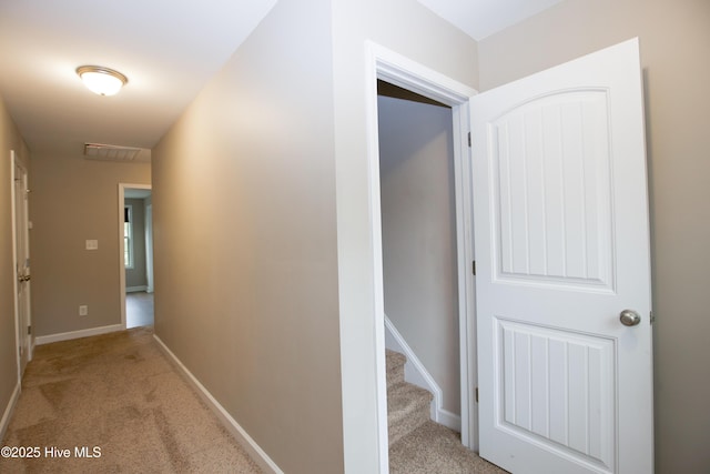 hallway featuring light colored carpet