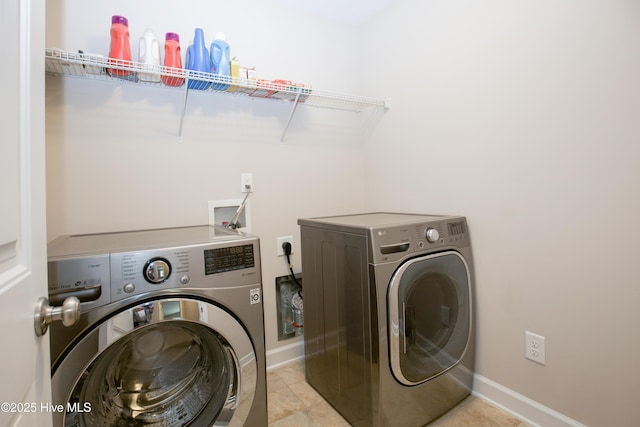 washroom with washer and dryer