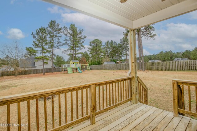 deck with a yard and a playground