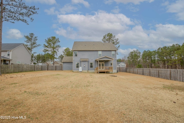 rear view of house featuring a wooden deck