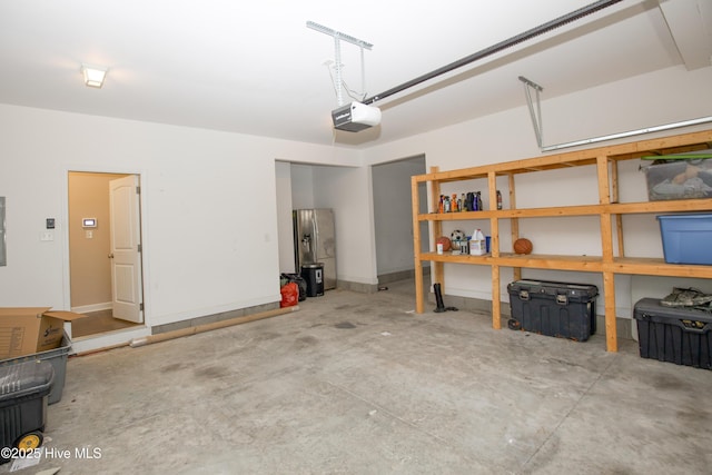 garage featuring electric panel and a garage door opener