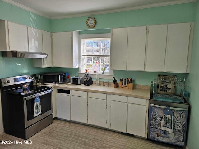 kitchen featuring electric range, white cabinets, and crown molding