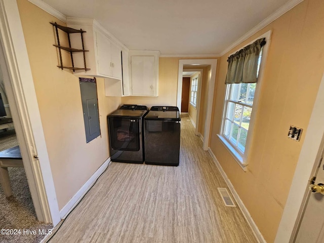 washroom with electric panel, cabinets, crown molding, and washing machine and clothes dryer