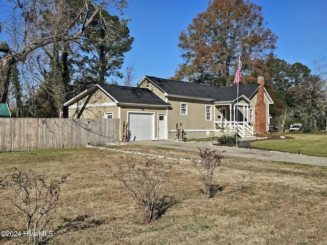 view of front of house featuring a front yard and a garage