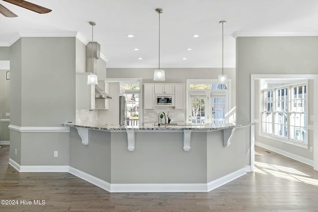 kitchen with white cabinets, decorative light fixtures, ceiling fan, and appliances with stainless steel finishes